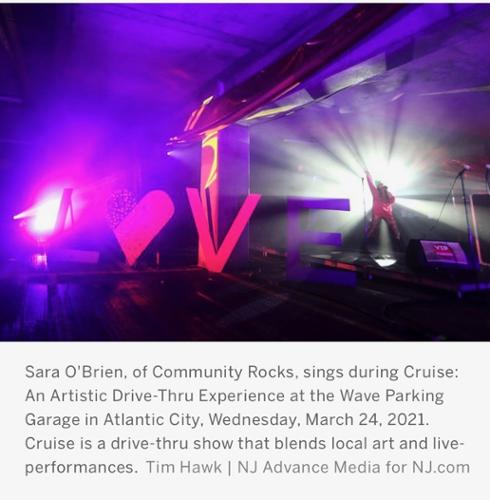 Sara O'Brien of Community Rocks sings during Cruise: An Artistic Drive-Thru Experience at the Wave Parking Lot in Atlantic City, NJ, Wednesday, March 24, 2021. Cruise is a drive-thru that show that blends local art and live-performances.